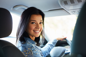 Young woman in driver's seat of a car.